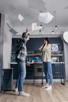 A dramatic scene of a young couple in a heated argument with papers flying in the air.